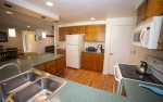 Fully equipped kitchen with electric four burner stove, all stainless steel pots and pans